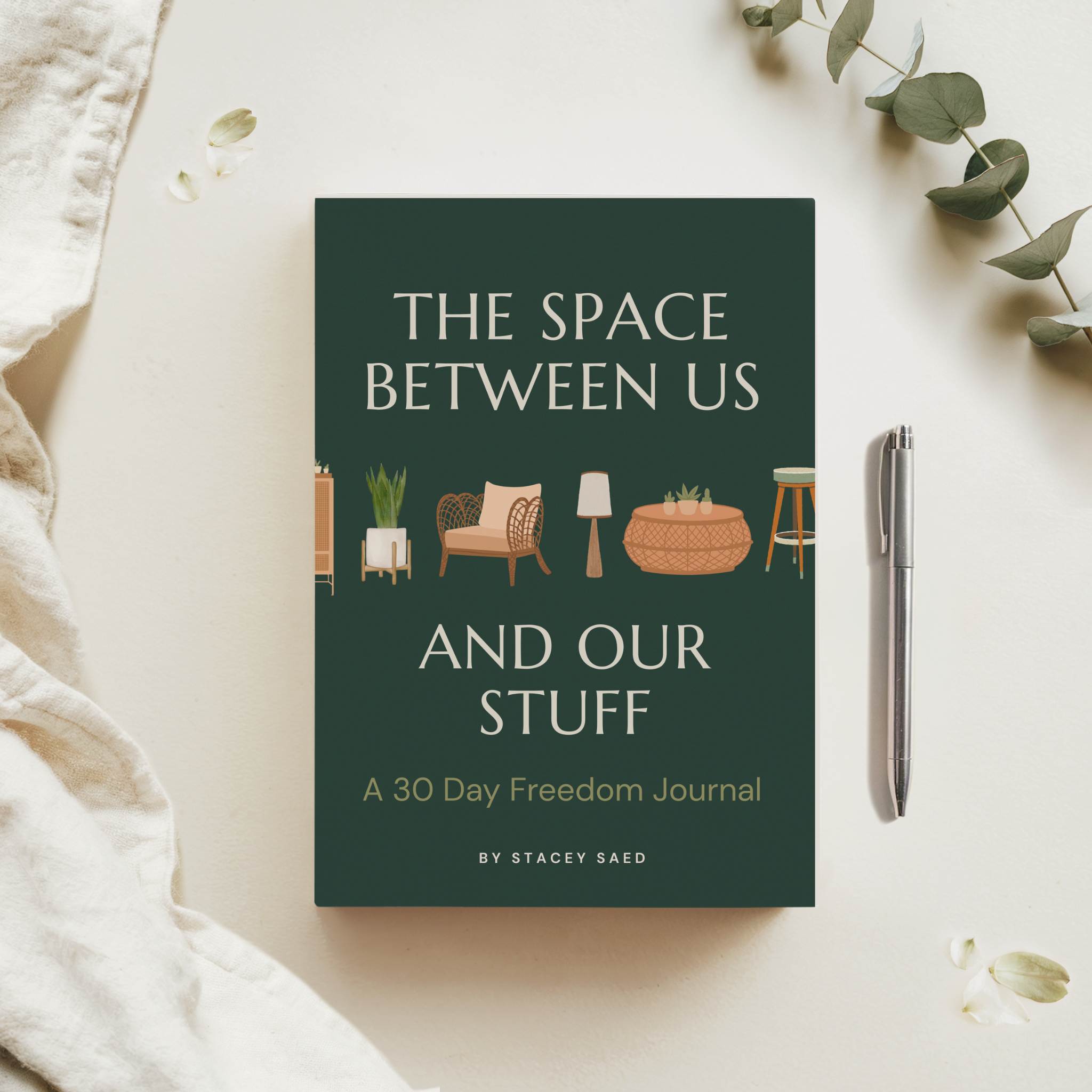 A flatlay image of The Space Between Us and Our Stuff: A 30 Day Freedom Journal by Stacey Saed.